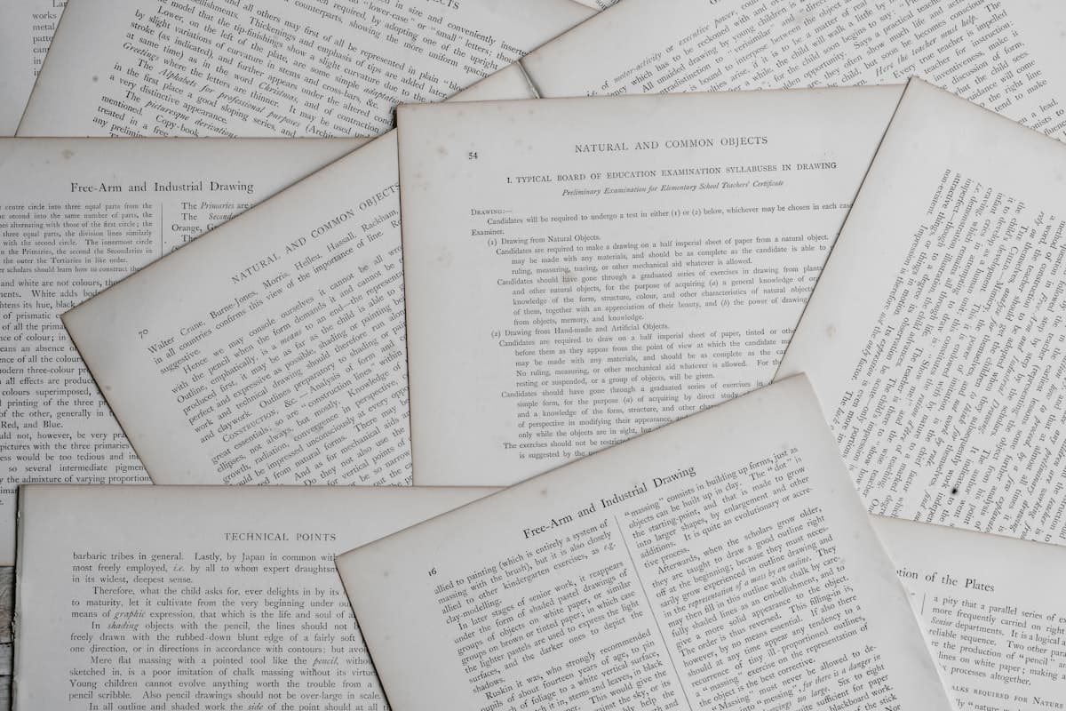 Open historical book and notebook — preparing for the GED Social Studies test