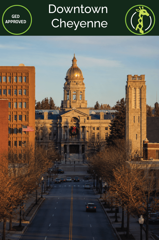 The Wyoming State Capitol dome in downtown Cheyenne under a wide blue sky.