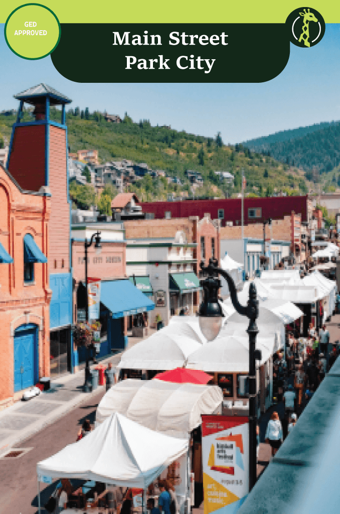 The historic Main Street of Old Town Park City, Utah, with ski runs on the mountainside above.