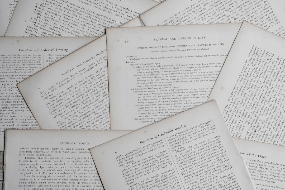 Open historical book and notebook — preparing for the GED Social Studies test